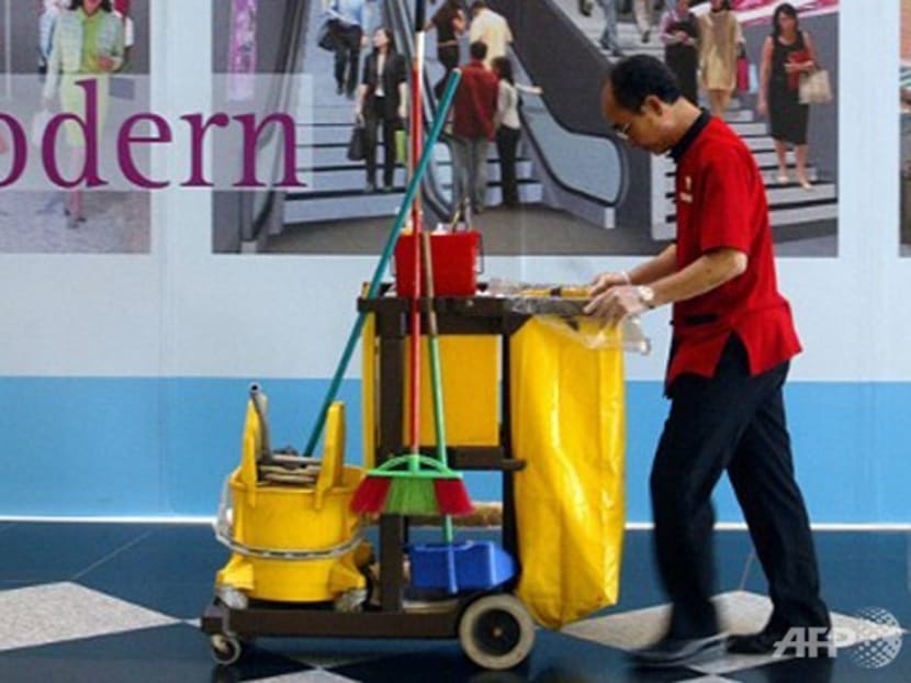 A cleaner pushes his trolley in a shopping centre in Singapore. Photo: Channel NewsAsia