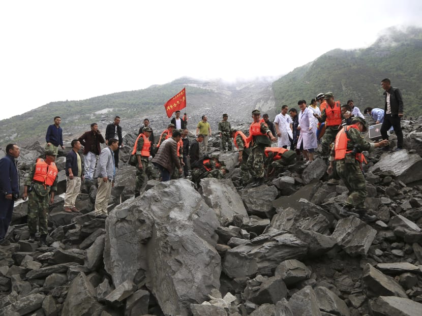 In this photo released by China's Xinhua News Agency, emergency personnel work at the site of a landslide in Xinmo village in Maoxian County in southwestern China's Sichuan Province, Saturday, June 24, 2017. Photo: AP