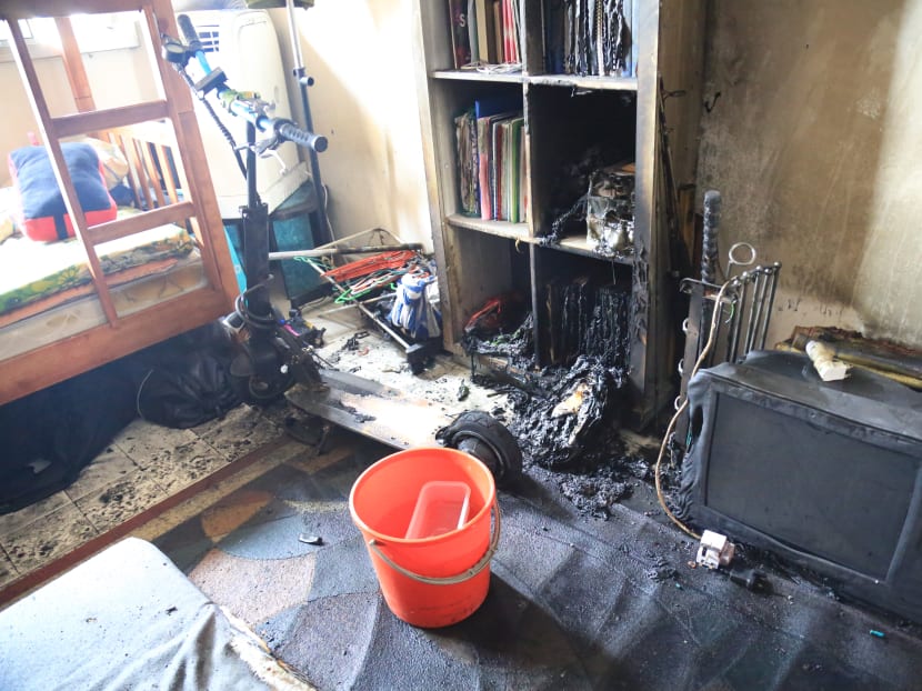A fire, which was started by an e-scooter left charging in a bedroom of a residential unit at Block 260 Yishun Street 22, damaged the bedroom and injured four residents. Photo: SCDF