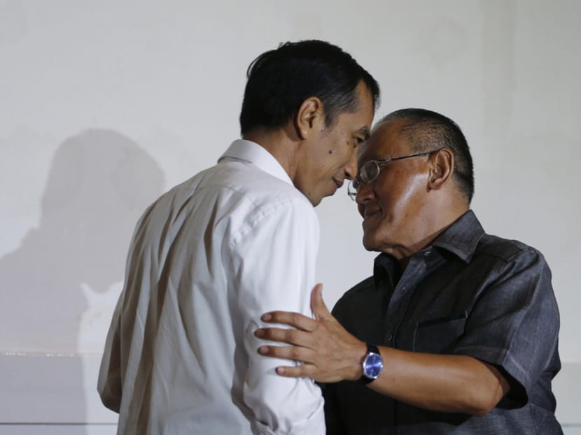 Golkar chairman Aburizal Bakrie (right), seen here with President Widodo, already has about 70 per cent of the vote to retain leadership of Indonesia’s second-largest political party. Photo: Reuters