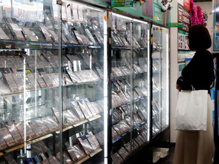 A customer looks at a display of used mobile phones in Iosys Corp's shop selling used smartphones at Akihabara electronics district in Tokyo, Japan Oct 28, 2022. A customer looks at a display of used mobile phones in Iosys Corp's shop selling used smartphones at Akihabara electronics district in Tokyo, Japan Oct 28, 2022.
