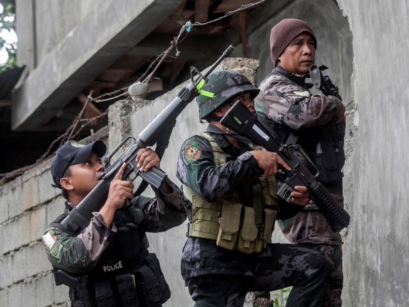 Police and military forces conducting a house-to-house search as part of clearing operations in Marawi City on Wednesday. Indonesia said that members of terrorist group JAD have been involved in the battle. Photo: Reuters