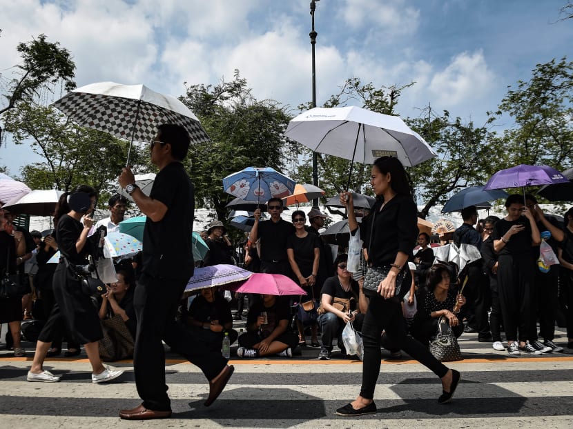 Thousands of mourners clad in black gather on the streets near the Grand Palace to pay respects to the late Thai King Bhumibol Adulyadej in Bangkok on October 22, 2016. Photo: AFP