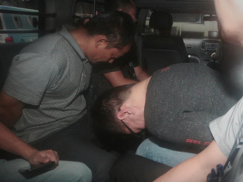 Two of the suspects being brought to court on Sat. Photo: Jason Quah / TODAY