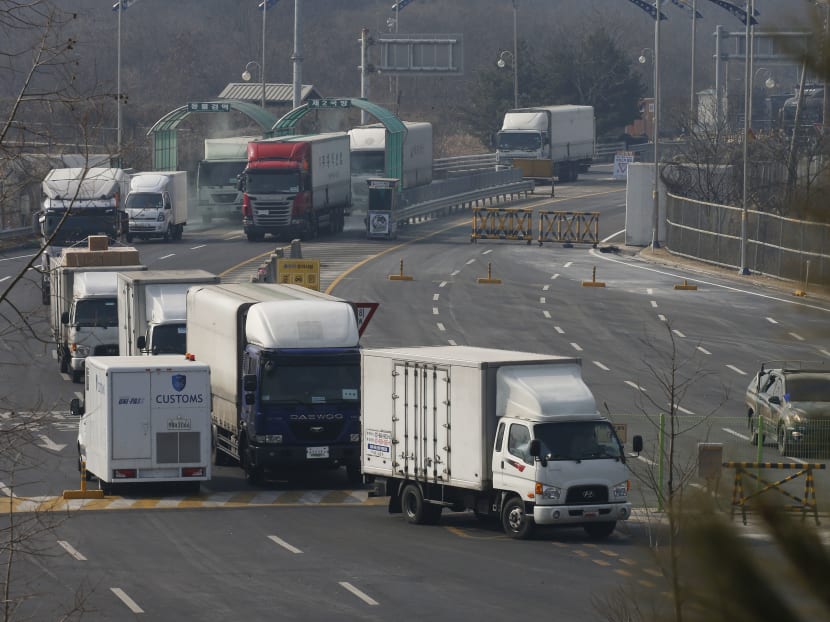 Vehicles leaving the Kaesong joint industrial zone pass through disinfectant spray before a checkpoint at the CIQ immigration centre near the Demilitarised Zone (DMZ) separating North an South Korea, in Paju on Feb 11, 2016. Photo: AFP