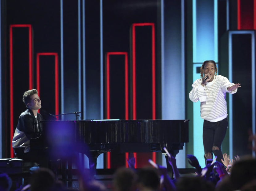 In this March 12, 2016, file photo, Charlie Puth, left, and Wiz Khalifa perform at the Kids' Choice Awards at The Forum in Inglewood, Calif. Wiz Khalifa’s video for “See You Again” featuring Puth is now the site’s most-watched video ever, with more than 2.896 billion views Tuesday, July 11, 2017. Photo: AP