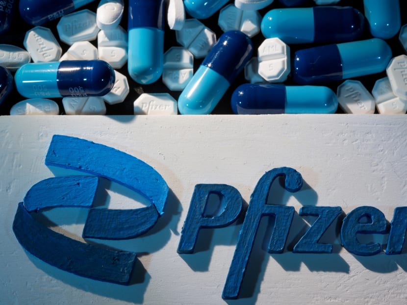 A 3D printed Pfizer logo is placed near medicines from the same manufacturer in this illustration.