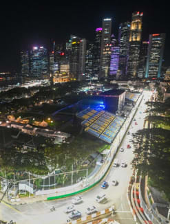 Cars drive on the illuminated race track for the upcoming Formula One Singapore Grand Prix night race at the Marina Bay Street Circuit in Singapore on Sept 26, 2022.