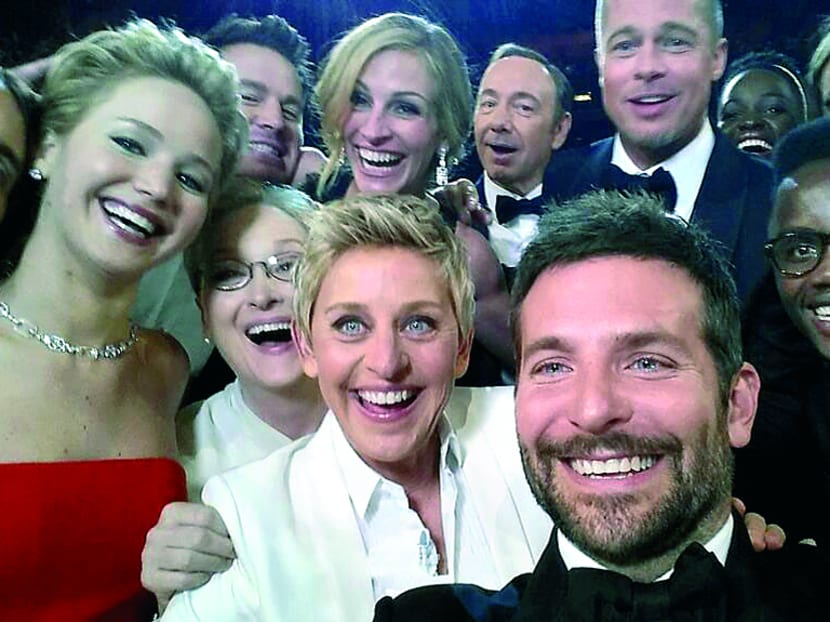 This image released by Ellen DeGeneres shows actors front row from left, Jared Leto, Jennifer Lawrence, Meryl Streep, Ellen DeGeneres, Bradley Cooper, Peter Nyong’o Jr., and, second row, from left, Channing Tatum, Julia Roberts, Kevin Spacey, Brad Pitt, Lupita Nyong’o and Angelina Jolie as they pose for a "selfie" portrait on a cell phone during the Oscars at the Dolby Theatre last year in Los Angeles. Photo: AP (via Ellen DeGeneres)