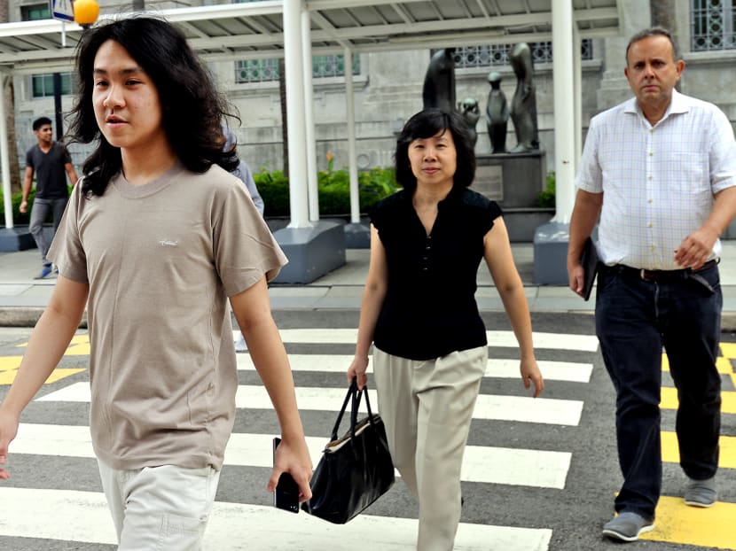 Amos Yee with his mother at the State Courts on Thursday (May 26). The prosecution has sought an urgent pre-trial conference as the blogger has raised the tempo of his online posts. Photo: Robin Choo