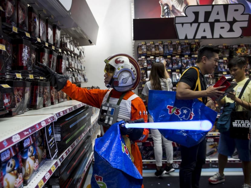 A shopper in a Toys "R" Us store dressed up as a Star Wars character during the popular "Force Friday". Toys "R" Us (Asia) said the stores in the region would remain open even though the US parent was filing for bankruptcy. Reuters file photo.