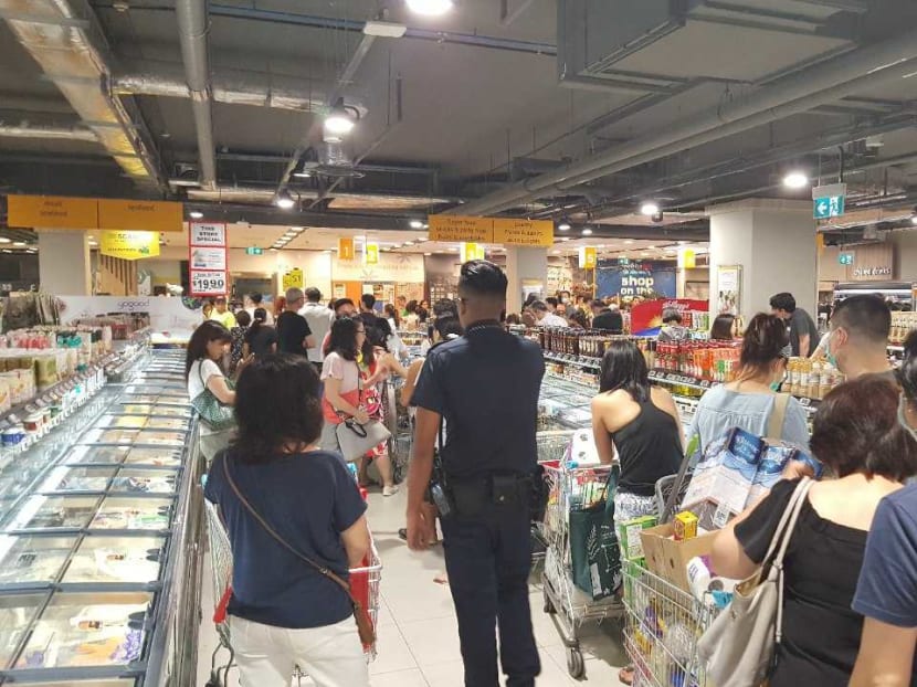 The scene at NTUC Finest at Bukit Timah Plaza in the hours after Malaysia announced its national lockdown on March 16, 2020.