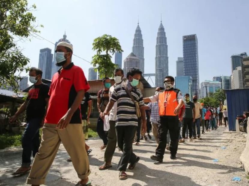 Foreign workers queue up to be tested for Covid-19 at Kampung Baru, Kuala Lumpur on April 16, 2020.