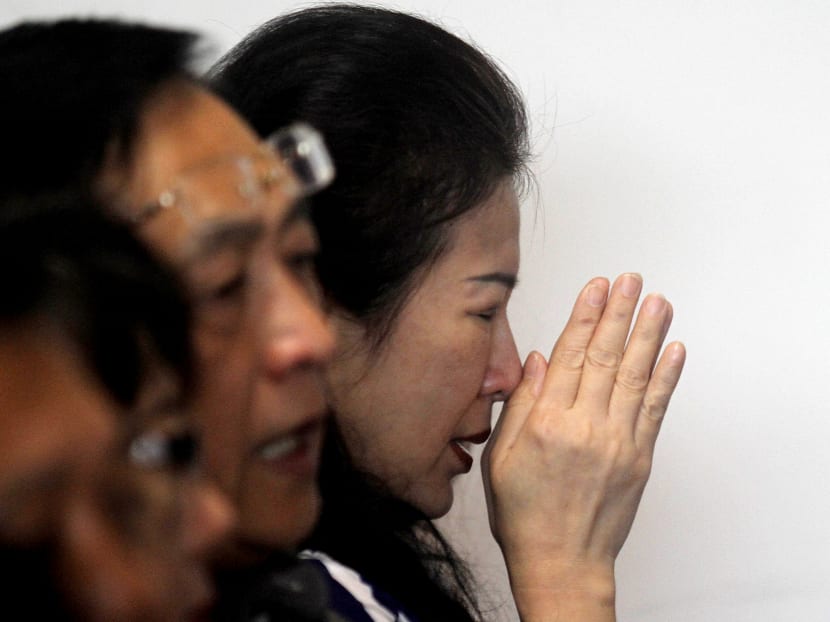 Relatives and next-of-kin of passengers on the AirAsia flight QZ8501 wait for the latest news on the search of the missing jetliner at Juanda International Airport in Surabaya, Dec 29, 2014. Photo: AP