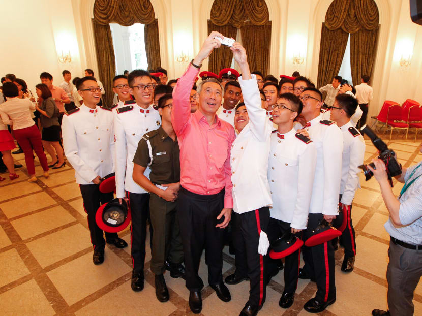PM Lee Hsien Loong prepares to take photo with Presidential Guards from the Military Police Command during the National Day Observance Ceremony at the Istana. Photo: Don Wong