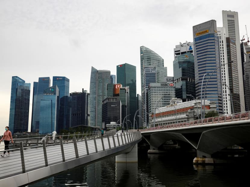 A woman wearing a protective face mask walking in Singapore's business district during a partial lockdown on May 27, 2020. A woman wearing a protective face mask walking in Singapore's business district during a partial lockdown on May 27, 2020.