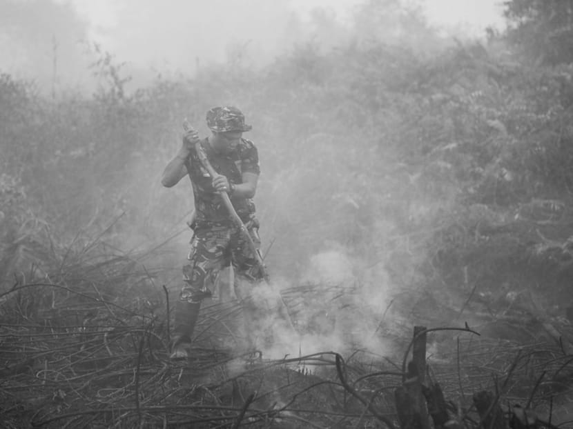 An Indonesian soldier checks on a peatland fire near Palangkaraya, central Kalimantan, Indonesia. Indonesian boots are needed on the ground to fight fires and do everything possible to prevent new ones. Photo: REUTERS