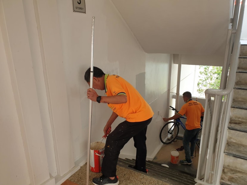 Workers from Nee Soon Town Council seen painting over bloodstains on the walls between the fourth and fifth floors of Block 653 Yishun Avenue 4 on Oct 11, 2022.