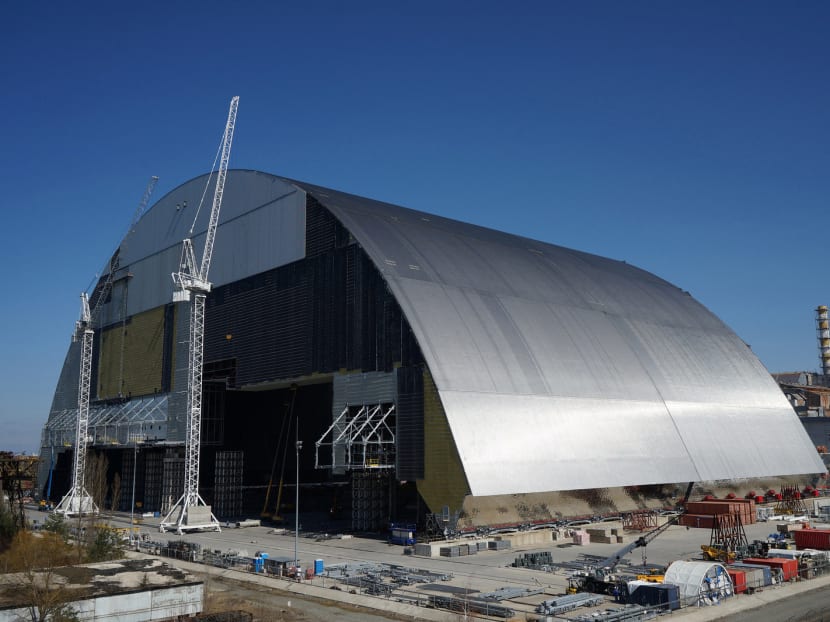 This handout picture taken and released by the European Bank for Reconstruction and Development (EBRD) Press-Service on November 14, 2016 shows Chernobyl's New Safe Confinement as a giant arch shielding radioactive waste from the 1986 Chernobyl nuclear disaster began sliding into place with a mission of keeping the site safe for generations to come.  Photo: AFP
