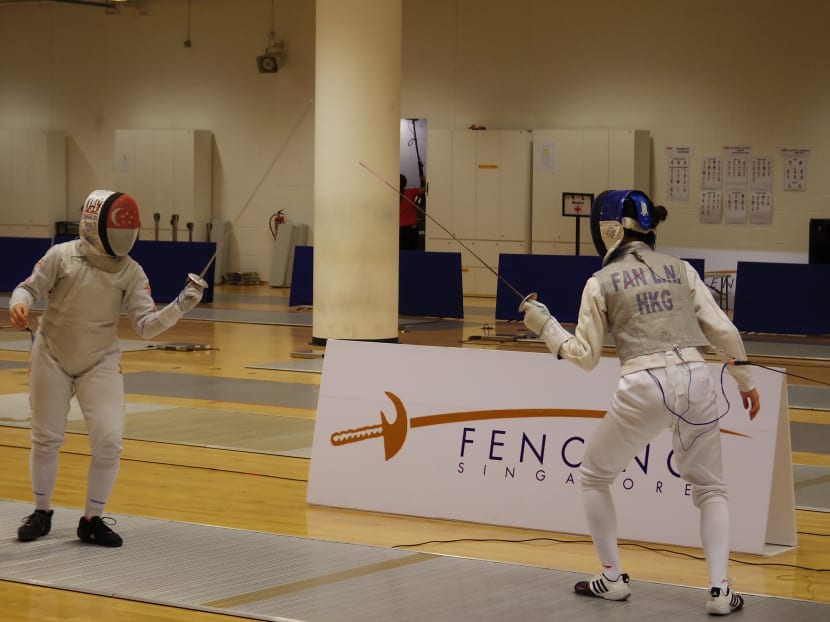 Maxine Wong (left) lived up to her favourite tag with a handy 15-11 win over Hong Kong’s Fan Linna in the girls’ final. Photo: Fencing Singapore