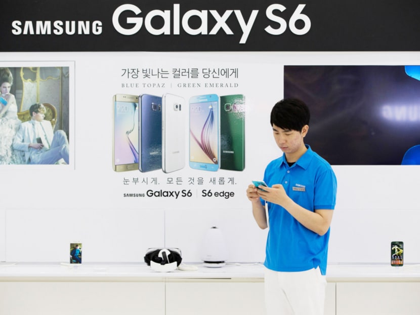 An employee with a Galaxy S6 Edge device at Samsung’s showroom in Seoul. Bloomberg