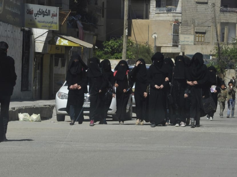 Female school students wearing a full veil in the northern province of Raqqa, controlled by Islamic State, on March 31, 2014. Photo: Reuters