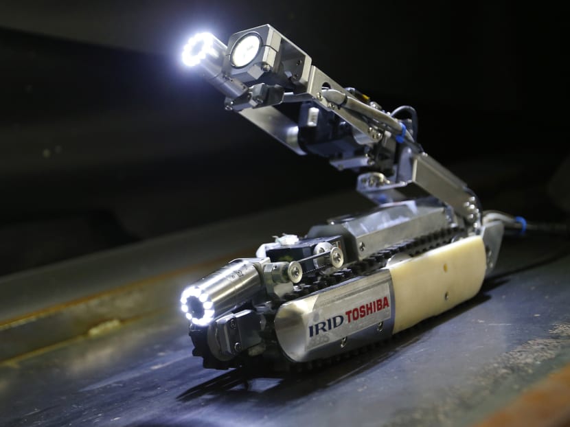A robot that looks like an enlarged fiberscope is controlled during a demonstration for the media at Toshiba Corp, in Kawasaki, near Tokyo. Photo: AP