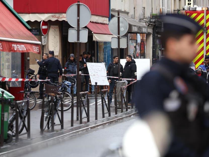 French police secure the street after several shots were fired along rue d'Enghien in the 10th arrondissement, in Paris on Dec 23, 2022. 
