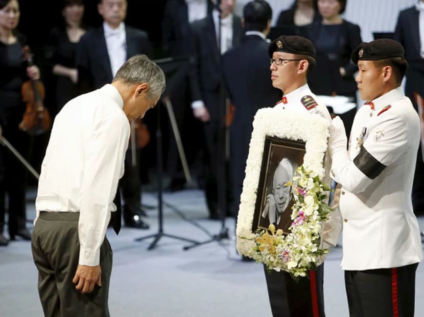 Prime Minister Lee Hsien Loong bows his head in front of a picture of his father Lee Kuan Yew during the latter's funeral at the University Cultural Centre at the National University of Singapore on March 29, 2015. Photo: Reuters