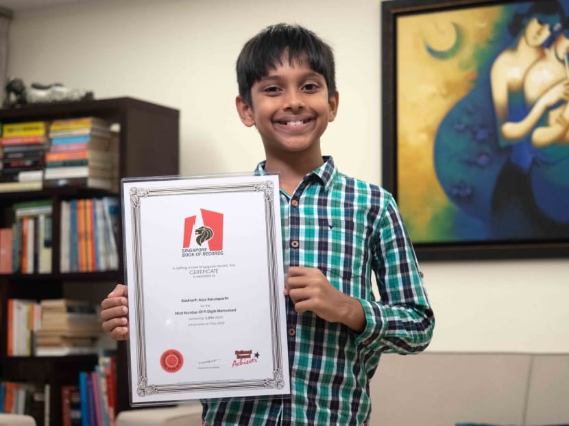 Siddharth Arya Ravulaparthi, 12, holds up his Singapore book of records certificate for reciting the most digits of the Pi mathematical constant.