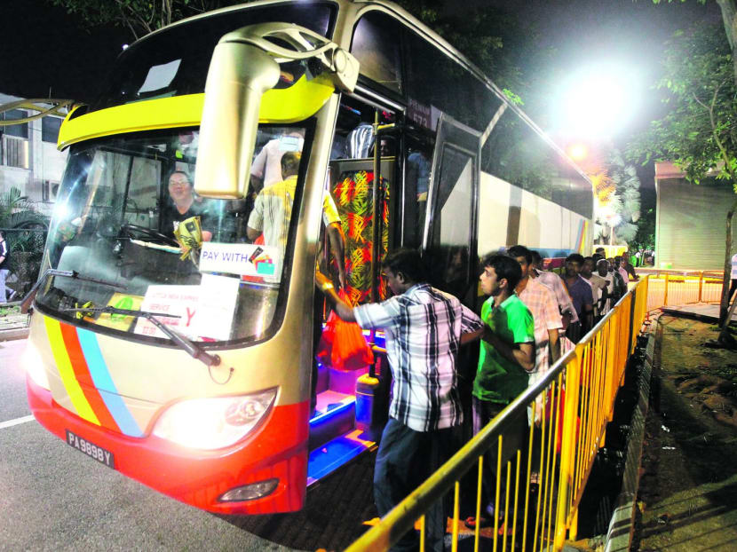 Workers boarding the buses in an orderly manner at Little India. Photo: Ernest Chua
