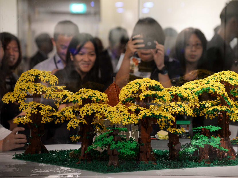Visitors taking photos of a Lego model of the Singapore Botanic Gardens, made using 12,000 bricks, at the Piece of Peace World Heritage Exhibit on display at the Fort Canning Arts Centre. Photo: Robin Choo/TODAY