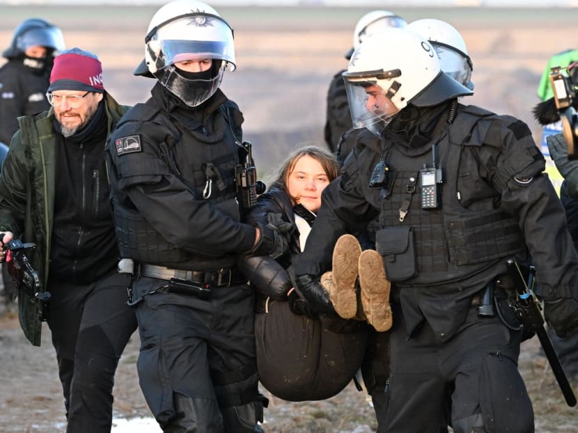 Police officers carry Swedish climate activist Greta Thunberg (centre) out of a group of demonstrators and activists in Erkelenz, western Germany, on Jan 17, 2023, as demonstrations continue against a coal mine extension in the nearby village of Luetzerath. Police officers carry Swedish climate activist Greta Thunberg (centre) out of a group of demonstrators and activists in Erkelenz, western Germany, on Jan 17, 2023, as demonstrations continue against a coal mine extension in the nearby village of Luetzerath.