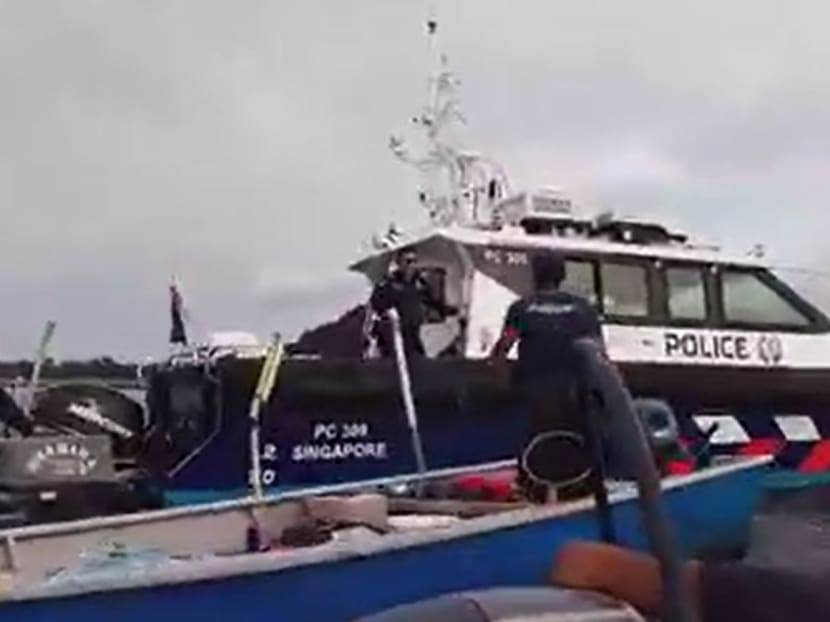A video screenshot on social media of an exchange between Singapore's Police Coast Guard and several Malaysian fishing vessels. 