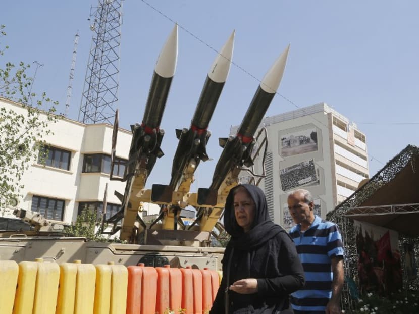 Iranians walk past Sam-6 missiles displayed in the street during a war exhibition to commemorate the 1980-88 Iran-Iraq war at Baharestan square, south of Tehran on September 26, 2016.  Photo: AFP
