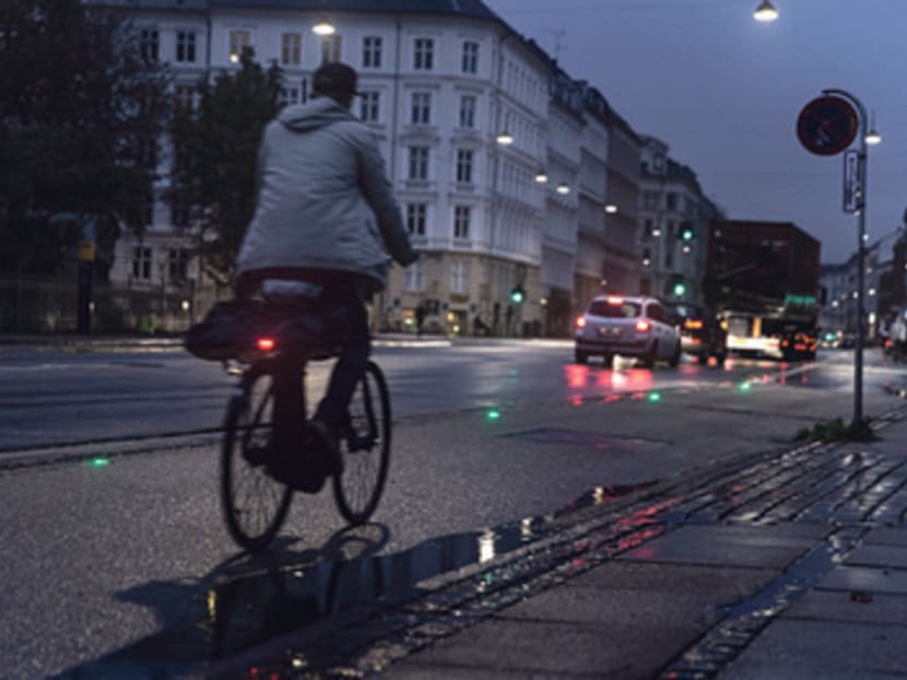 A string of green lights embedded in a bike path on a road helps cyclists avoid red traffic lights in Copenhagen, Denmark. Photo: 
The New York Times