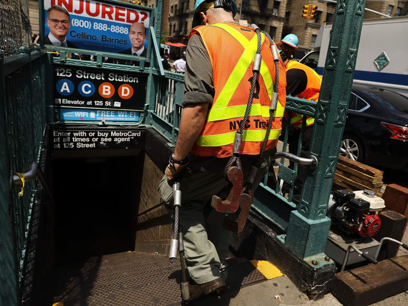 A Metropolitan Transportation Authority worker entering Harlem subway station where a morning train derailment occurred on June 27, 2017 in New York City. Photo: AFP