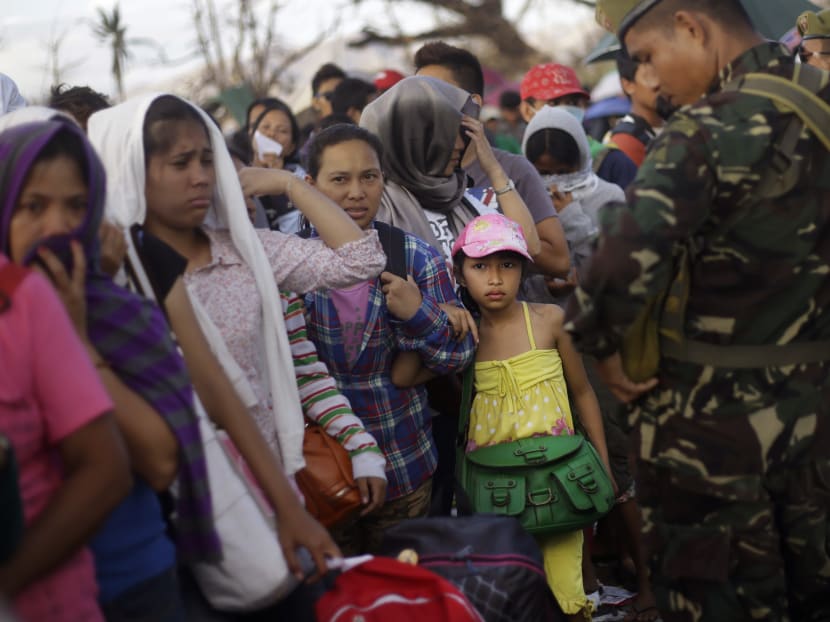 Typhoon Haiyan survivors queue up to get into any evacuation flight at the airport in Tacloban, Philippines. Hundreds of thousands of people were displaced by Typhoon Haiyan, which tore across several islands in the eastern Philippines. AP file photo