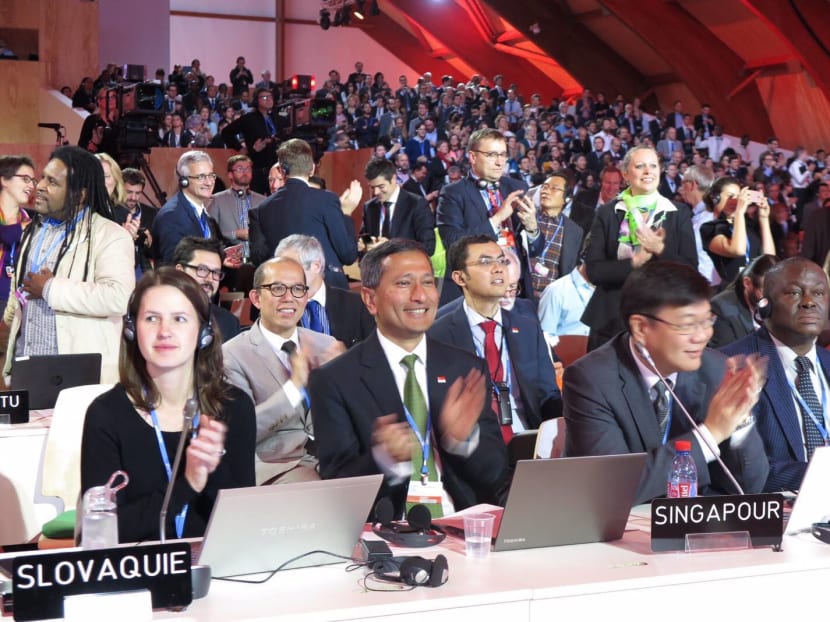 Dr Vivian Balakrishnan (second from left) and Chief Negotiator Mr Kwok Fook Seng (third from left) applauding at the Paris Climate Conference. Photo: Dr Vivian Balakrishnan/Facebook