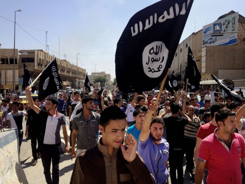 Demonstrators chant pro-Islamic State slogans as they wave the group's flag in Mosul, 362km northwest of Baghdad, Iraq, on June 16, 2014. Photo: AP