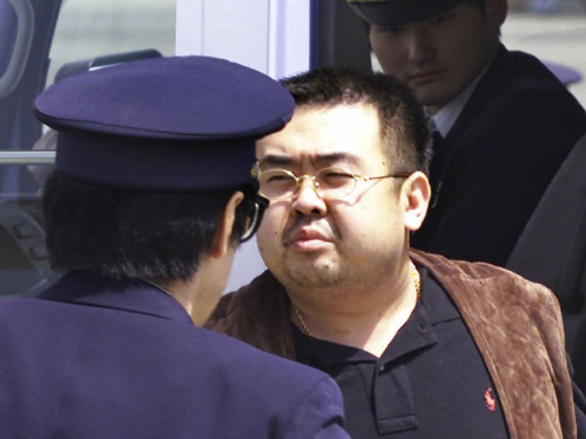 Kim Jong-nam, exiled half brother of North Korea's leader Kim Jong-un, escorted by Japanese police officers at the airport in Narita, Japan. Photo: AP