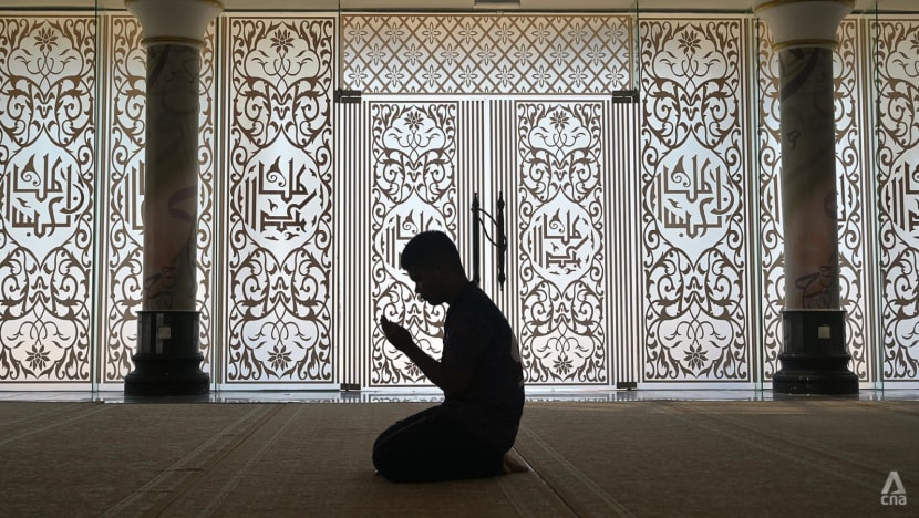 a man perform a prayers inside a mosque in kuala terengganu