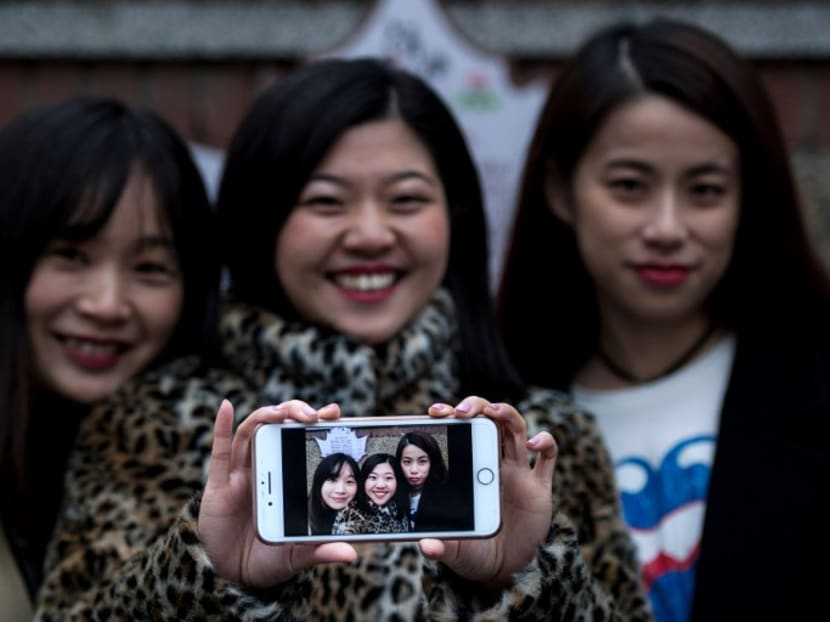 (From left) Ms Hu Dongyuan, Ms Wang Peng and Ms Peng Lin displaying their selfie in Shanghai. Photo: AFP