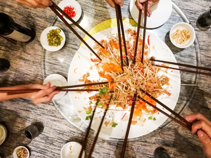 Diners must wear a mask during the tossing of yusheng — a raw fish salad tossed by diners around the table, which is usually accompanied by the chanting of auspicious phrases for the new year. Diners must wear a mask during the tossing of yusheng — a raw fish salad tossed by diners around the table, which is usually accompanied by the chanting of auspicious phrases for the new year.