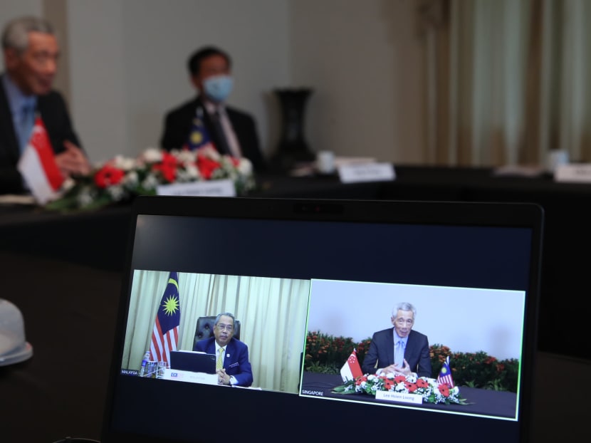 Prime Minister Lee Hsien Loong (right, on screen) and his Malaysian counterpart Muhyiddin Yassin (left, on screen) during a conference call to discuss the Kuala Lumpur-Singapore High Speed Rail project on Dec 2, 2020.