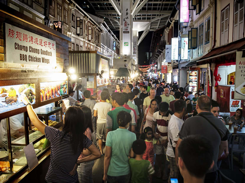 Diners at Chinatown Food Street last month. Housing, food and transport continued to account for the largest shares of household expenditure, totalling 65 per cent. PHOTO: BLOOMBERG