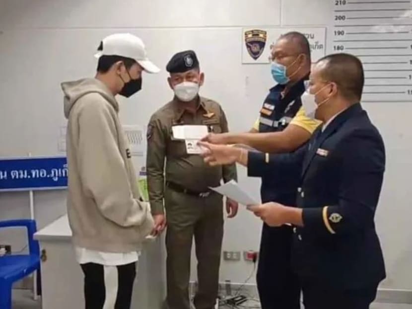 Daryl Cai Younghui, 32, being apprehended by authorities at the Phuket airport. He is suspected of involvement in a major ponzi scheme which defrauded a total of 2.4 billion baht from the public.