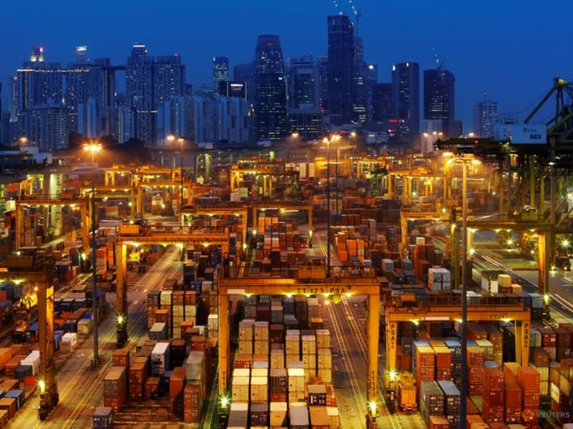 The skyline of Singapore's central business district is seen at dusk with PSA international port terminal in the foreground on Sept 25, 2013.