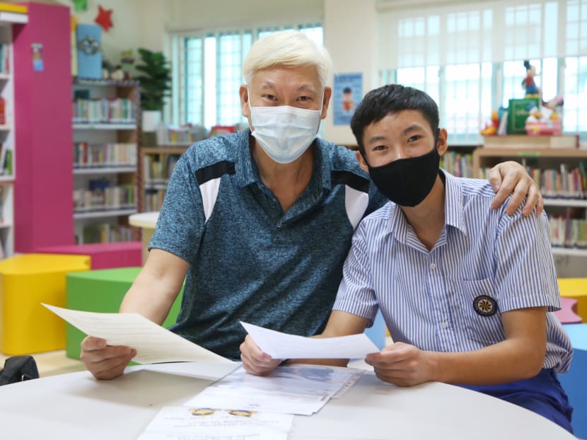 Michael Wong Hsi Wah (right) with his father Toni Wong Kwan Ying in a photo taken when the Primary School Leaving Examination results were released on Nov 24, 2021.
