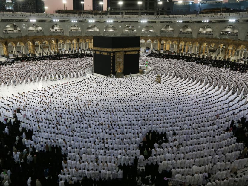 Muslims pray around the Kaaba, Islam's holiest shrine, at the Grand Mosque complex in the Saudi city of Mecca, during the fasting month of Ramadan, on April 9, 2022. 
